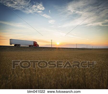 Truck driving on remote road View Large Photo Image Stock Image - Truck driving on remote road. Fotosearch