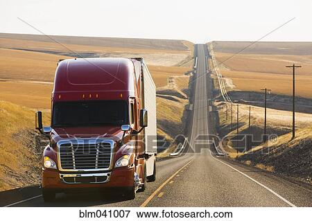 Stock Photo - Truck driving on remote road. Fotosearch