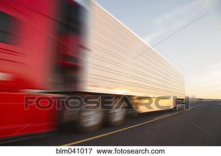 Stock Photo - Truck driving on remote road. Fotosearch