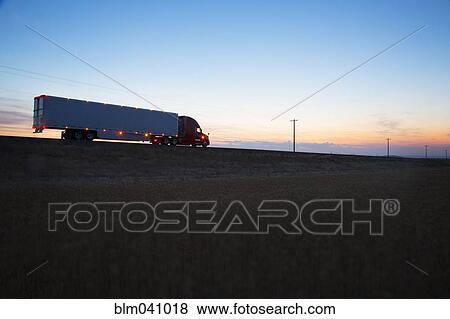 Stock Photo - Truck driving on remote road. Fotosearch