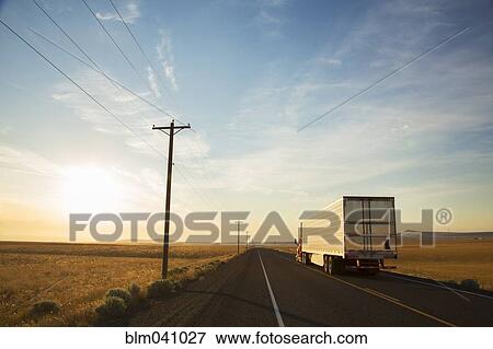 Stock Photo - Truck driving on remote road. Fotosearch