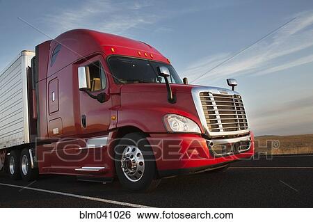 Stock Photograph - Truck driving on remote road. Fotosearch