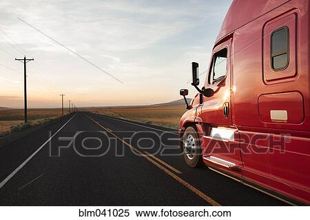 Stock Photography - Truck driving on remote road. Fotosearch
