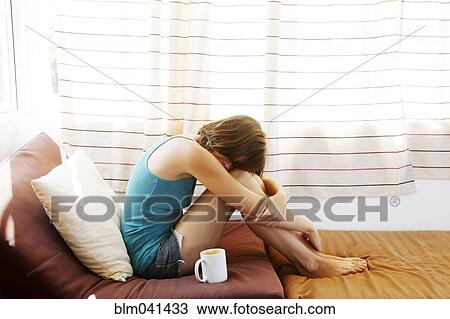 Stock Image - Woman sitting at window. Fotosearch