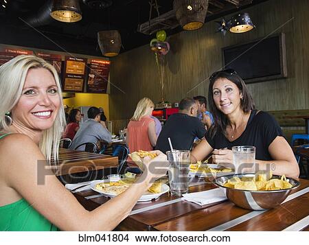 Picture - Women eating in cafe. Fotosearch