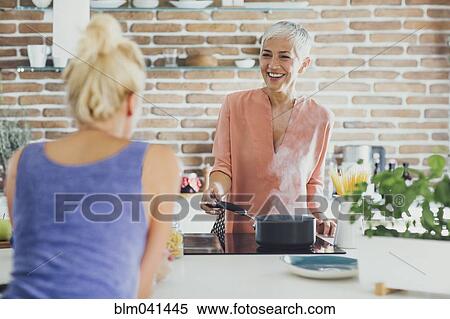Women talking in kitchen View Large Photo Image Stock Photography - Women talking in kitchen. Fotosearch