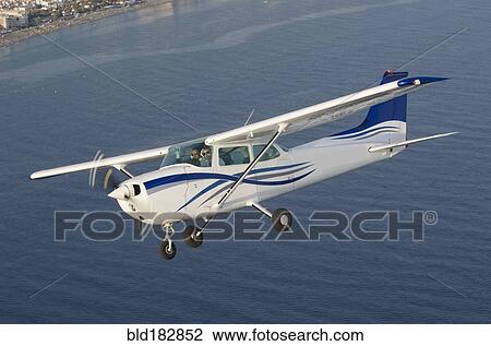 Aerial view of airplane flying over ocean View Large Photo Image Stock Image - Aerial view of airplane flying over ocean. Fotosearch