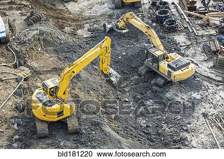 Aerial view of diggers at construction site View Large Photo Image Stock Image - Aerial view of diggers at construction site. Fotosearch