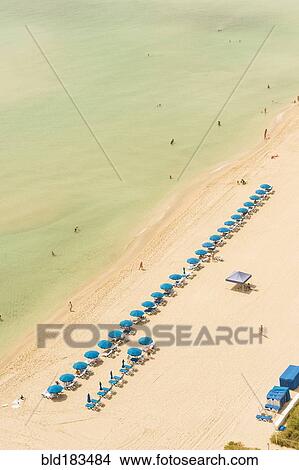 Aerial view of lawn chairs on beach View Large Photo Image Picture - Aerial view of lawn chairs on beach. Fotosearch