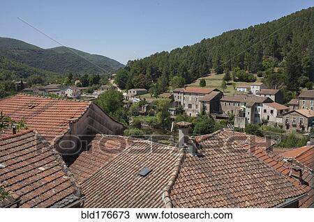 Stock Image - Aerial view of rooftops in rural village. Fotosearch