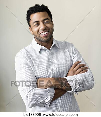 African American businessman smiling with arms crossed View Large Photo Image Stock Photograph - African American businessman smiling with arms crossed. Fotosearch