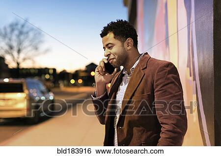 African American businessman talking on cell phone outdoors View Large Photo Image Stock Photograph - African American businessman talking on cell phone outdoors. Fotosearch