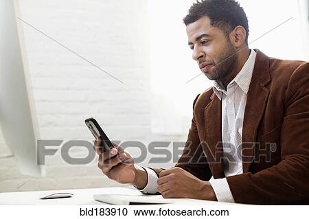 African American businessman using cell phone in office View Large Photo Image Stock Image - African American businessman using cell phone in office. Fotosearch