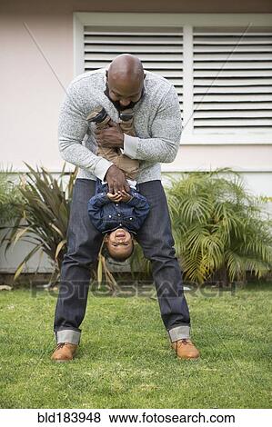 Stock Photo - African American father and son playing outdoors. Fotosearch