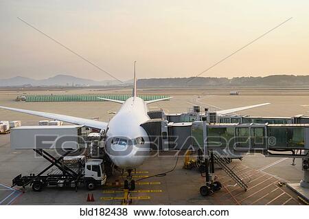 Stock Photo - Airplane and walkways at airport. Fotosearch
