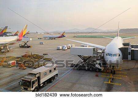 Stock Photo - Airplanes and walkways at airport. Fotosearch