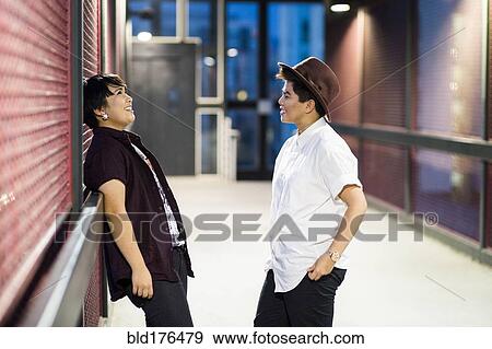 Stock Photo - Asian couple talking in hallway. Fotosearch