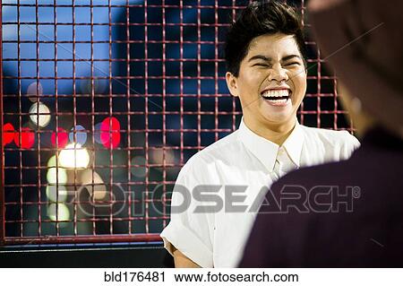 Stock Image - Asian couple talking outdoors. Fotosearch
