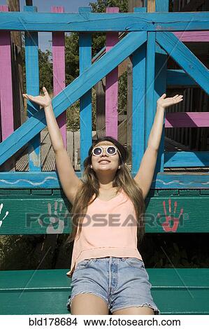 Picture - Asian woman cheering outdoors. Fotosearch