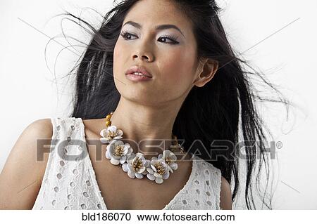 Stock Image - Asian woman wearing flower necklace. Fotosearch