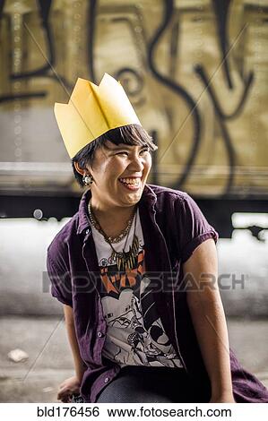 Asian woman wearing paper crown View Large Photo Image Stock Photograph - Asian woman wearing paper crown. Fotosearch