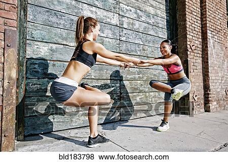 Stock Photo - Athletes balancing on sidewalk. Fotosearch