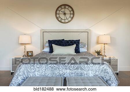 Stock Photo - Bed and lamps in ornate bedroom. Fotosearch