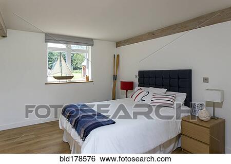 Stock Photograph - Bed and night table in modern bedroom. Fotosearch