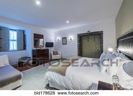 Bed and vanity in hotel room View Large Photo Image Stock Photo - Bed and vanity in hotel room. Fotosearch