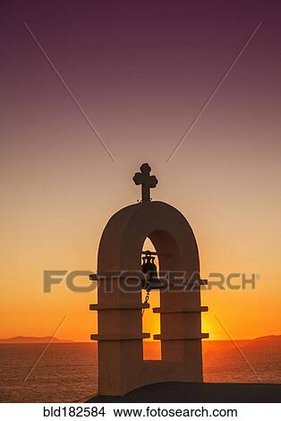 Picture - Bell arch with cross and sunset sky. Fotosearch