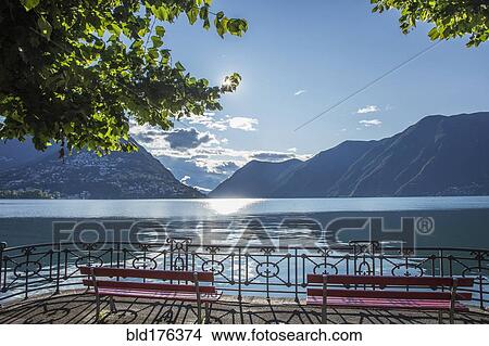 Picture - Benches overlooking mountains and remote lake. Fotosearch