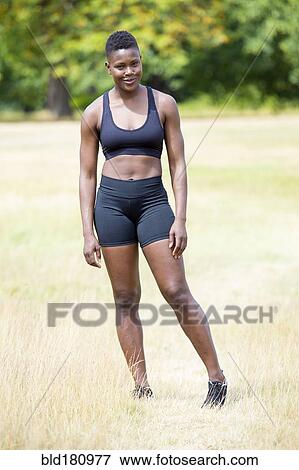 Stock Photo - Black athlete standing in park. Fotosearch
