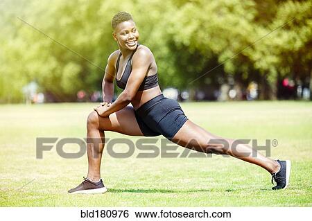 Black athlete stretching in park View Large Photo Image Stock Photograph - Black athlete stretching in park. Fotosearch