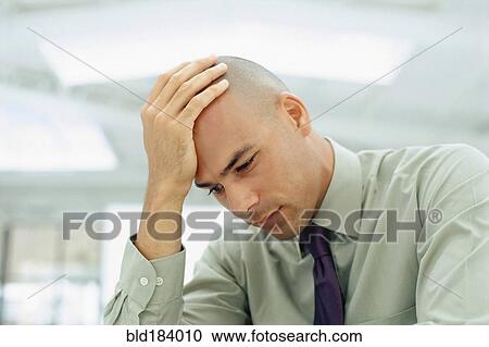 Black businessman rubbing his head View Large Photo Image Stock Image - Black businessman rubbing his head. Fotosearch