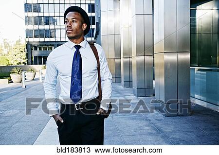 Black businessman walking outside office building View Large Photo Image Stock Image - Black businessman walking outside office building. Fotosearch