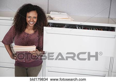 Picture - Black businesswoman smiling in office. Fotosearch