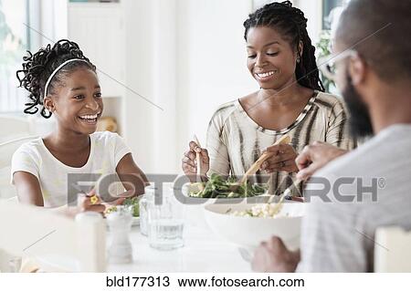 Black family eating salad at table View Large Photo Image Stock Image - Black family eating salad at table. Fotosearch