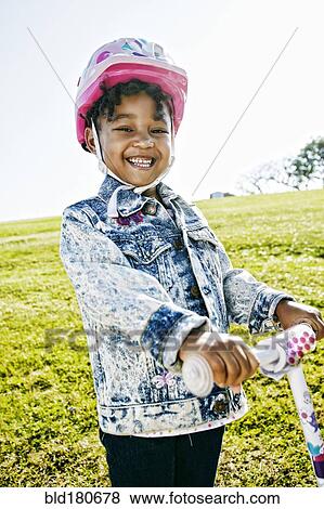 Black girl wearing helmet on scooter View Large Photo Image Stock Photo - Black girl wearing helmet on scooter. Fotosearch