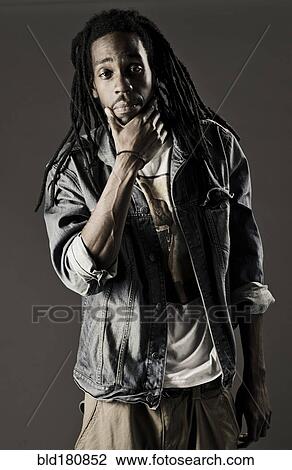 Stock Image - Black man scratching his chin. Fotosearch