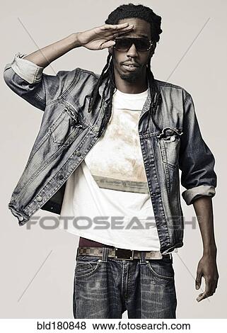 Stock Photo - Black man shielding eyes. Fotosearch