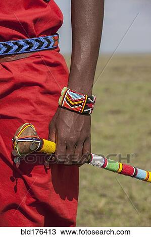 Stock Image - Black man with traditional bracelet and cane. Fotosearch