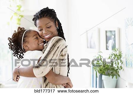 Black mother and daughter hugging View Large Photo Image Stock Photo - Black mother and daughter hugging. Fotosearch