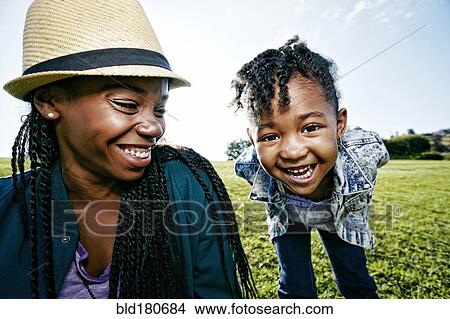 Black mother and daughter playing in park View Large Photo Image Picture - Black mother and daughter playing in park. Fotosearch