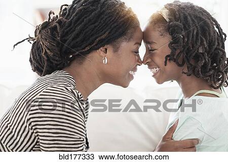 Black mother and daughter touching noses View Large Photo Image Stock Image - Black mother and daughter touching noses. Fotosearch