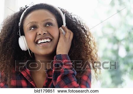 Black woman listening to headphones View Large Photo Image Stock Image - Black woman listening to headphones. Fotosearch