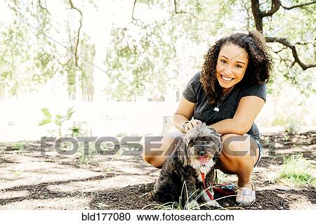 Black woman petting dog outdoors View Large Photo Image Stock Image - Black woman petting dog outdoors. Fotosearch