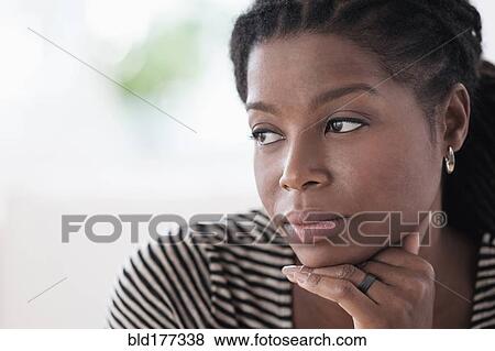 Stock Photo - Black woman resting chin in hand. Fotosearch