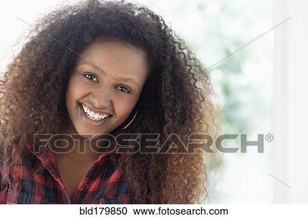 Black woman smiling indoors View Large Photo Image Stock Image - Black woman smiling indoors. Fotosearch
