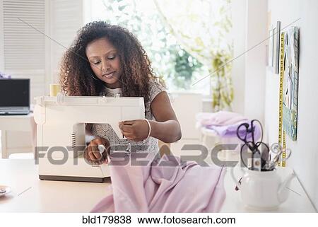 Black woman using sewing machine View Large Photo Image Stock Photo - Black woman using sewing machine. Fotosearch