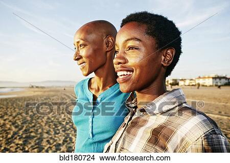 Picture - Black women smiling on beach. Fotosearch